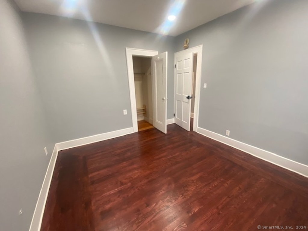 279 Wakelee Avenue Ansonia, CT 06401 - Photo 18 of 23 an empty room with wooden floor and windows
