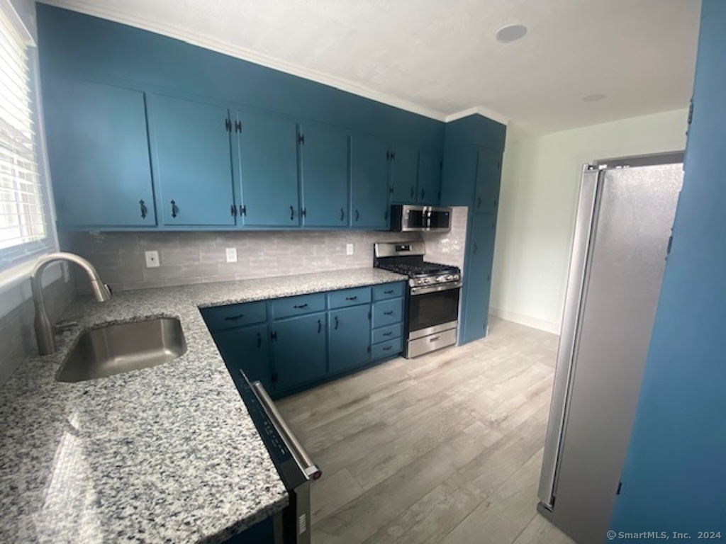 279 Wakelee Avenue Ansonia, CT 06401 - Photo 2 of 23 a kitchen with stainless steel appliances granite countertop a refrigerator sink and cabinets