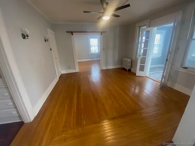 a view of hallway with wooden floor