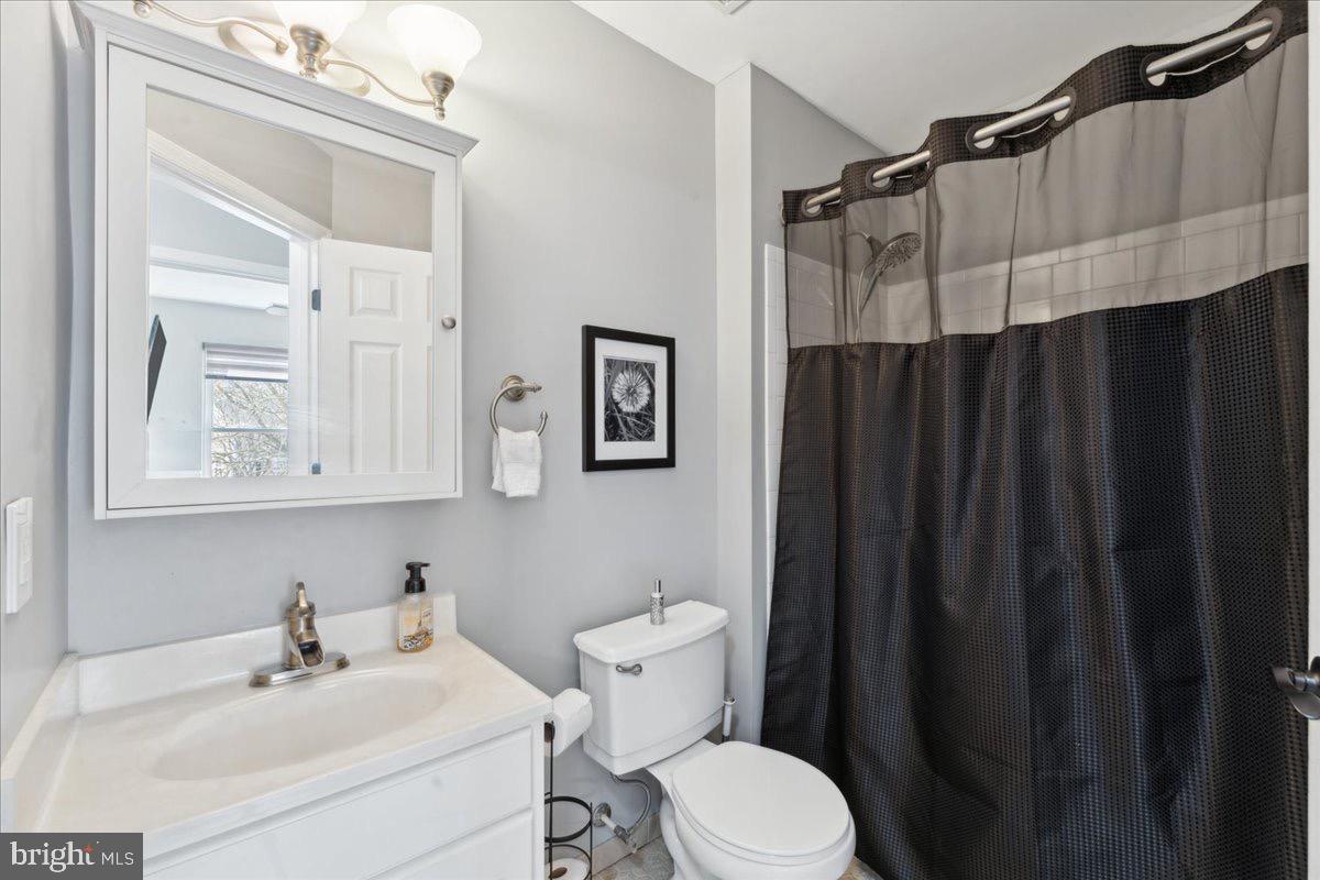 262 Arcadia Shores Circle Odenton, MD 21113 - Photo 15 of 37 a bathroom with a sink a mirror a toilet and shower