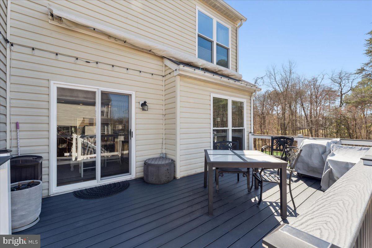 262 Arcadia Shores Circle Odenton, MD 21113 - Photo 22 of 37 a view of a patio with table and chairs and wooden floor