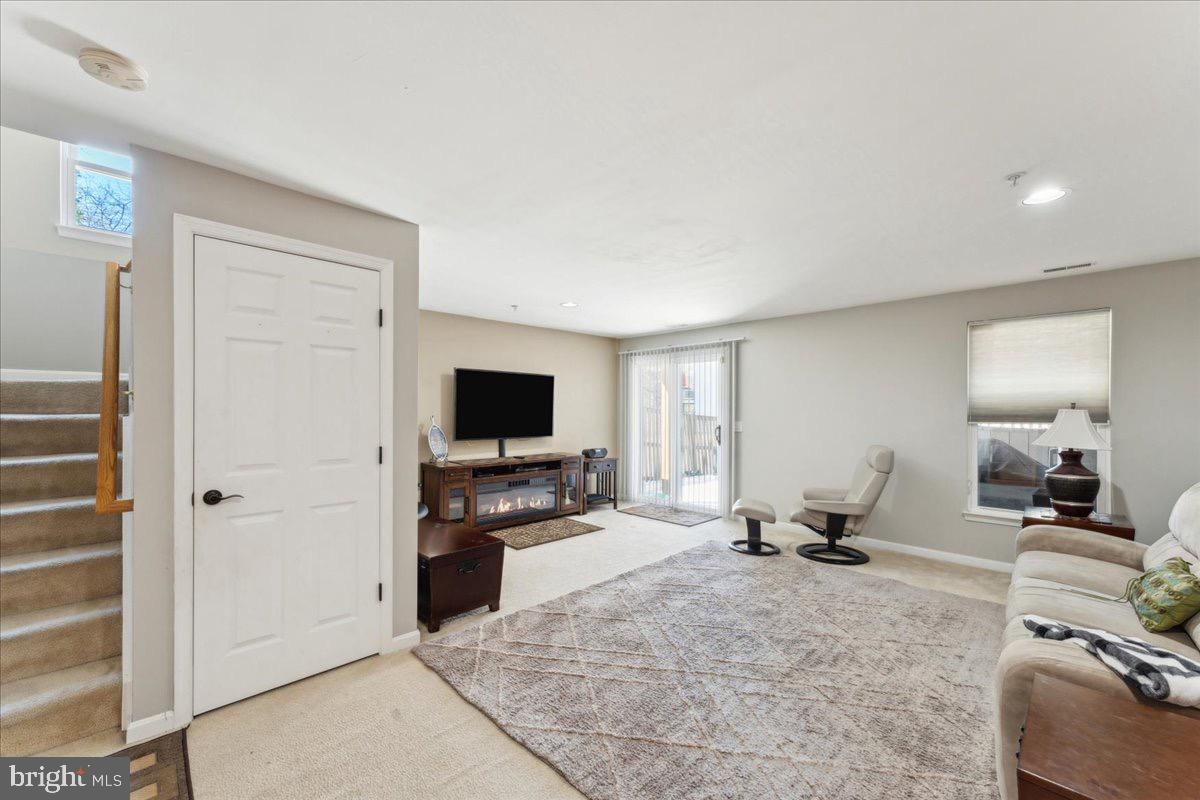 262 Arcadia Shores Circle Odenton, MD 21113 - Photo 23 of 37 a living room with furniture and a flat screen tv