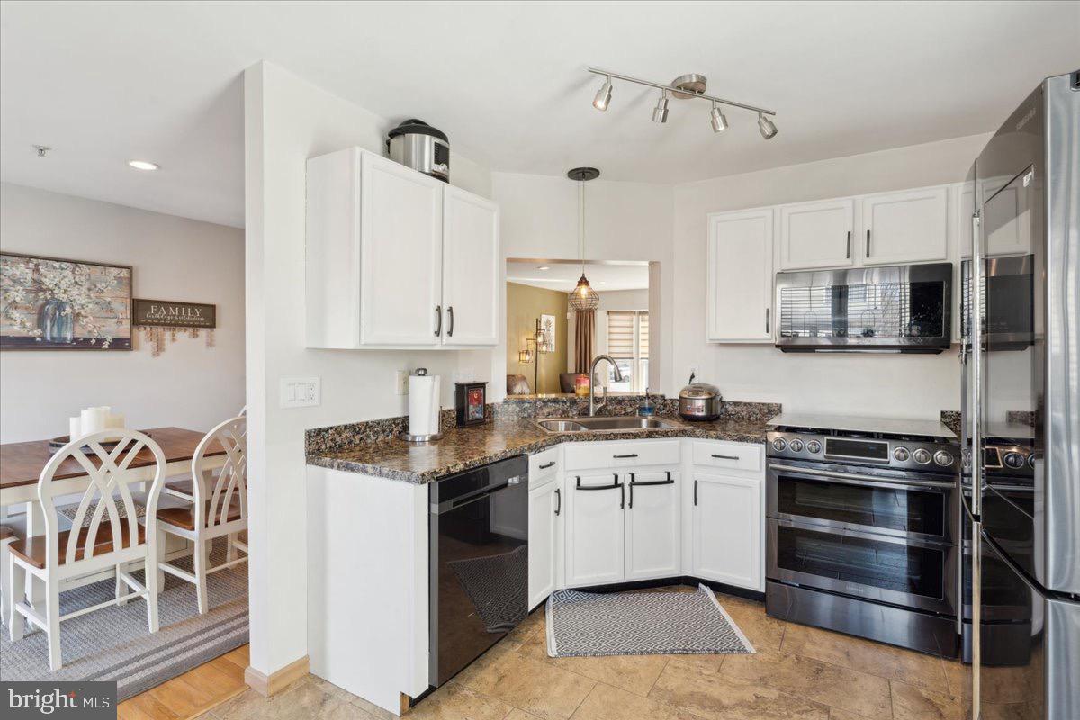 262 Arcadia Shores Circle Odenton, MD 21113 - Photo 10 of 37 a kitchen with stainless steel appliances granite countertop a stove sink and cabinets