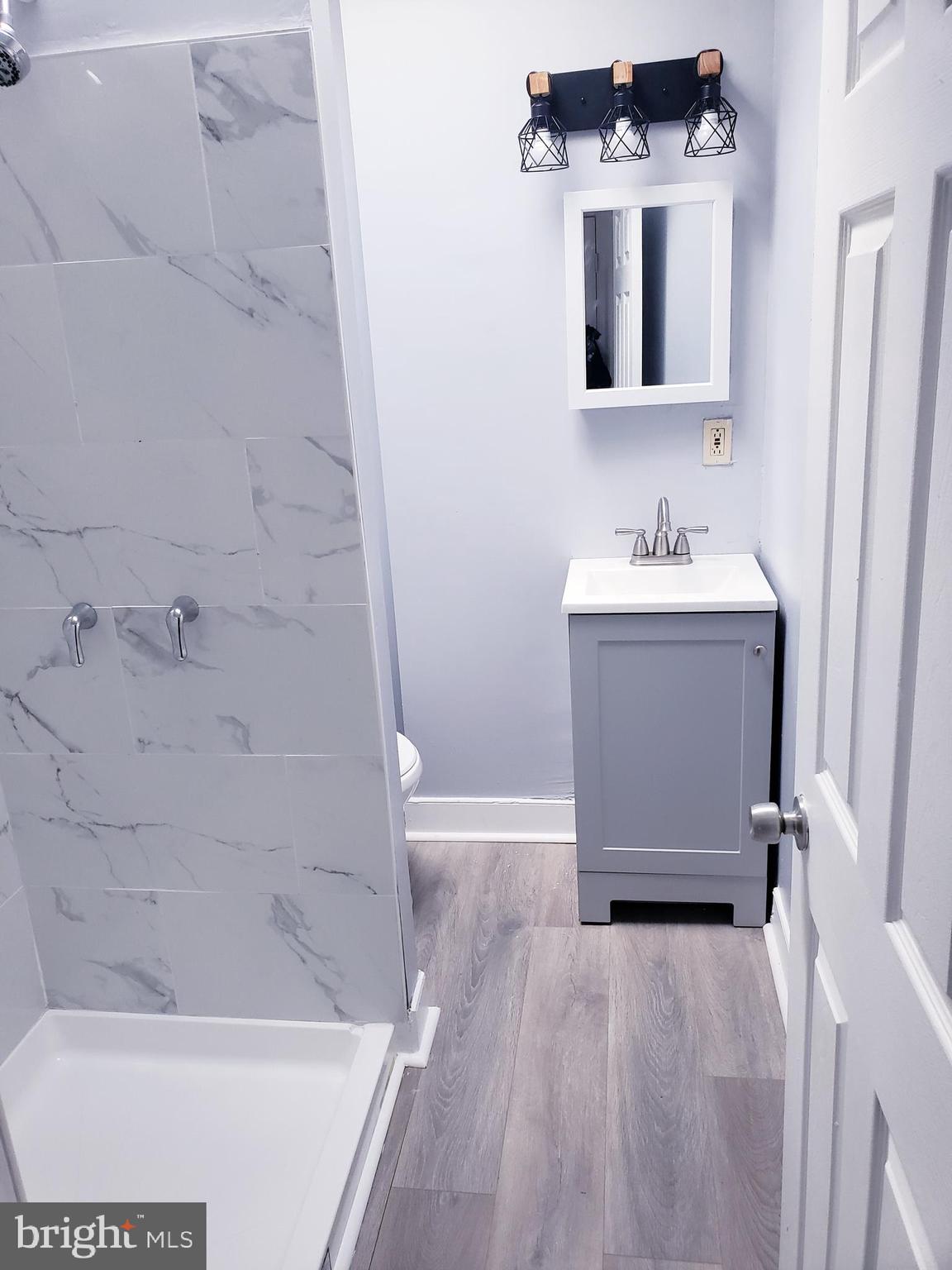 a bathroom with a sink toilet and shower