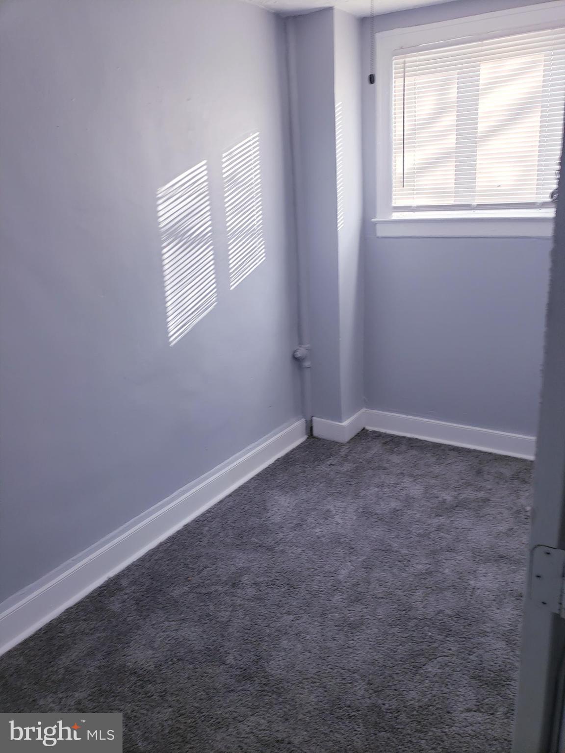3441 Elmora Avenue Baltimore, MD 21213 - Photo 7 of 10 an empty room with a window