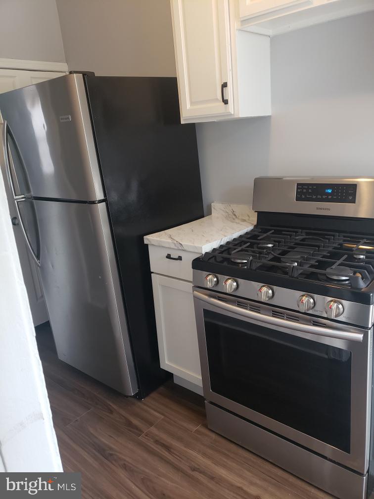 3441 Elmora Avenue Baltimore, MD 21213 - Photo 9 of 10 a stove top oven sitting inside of a kitchen