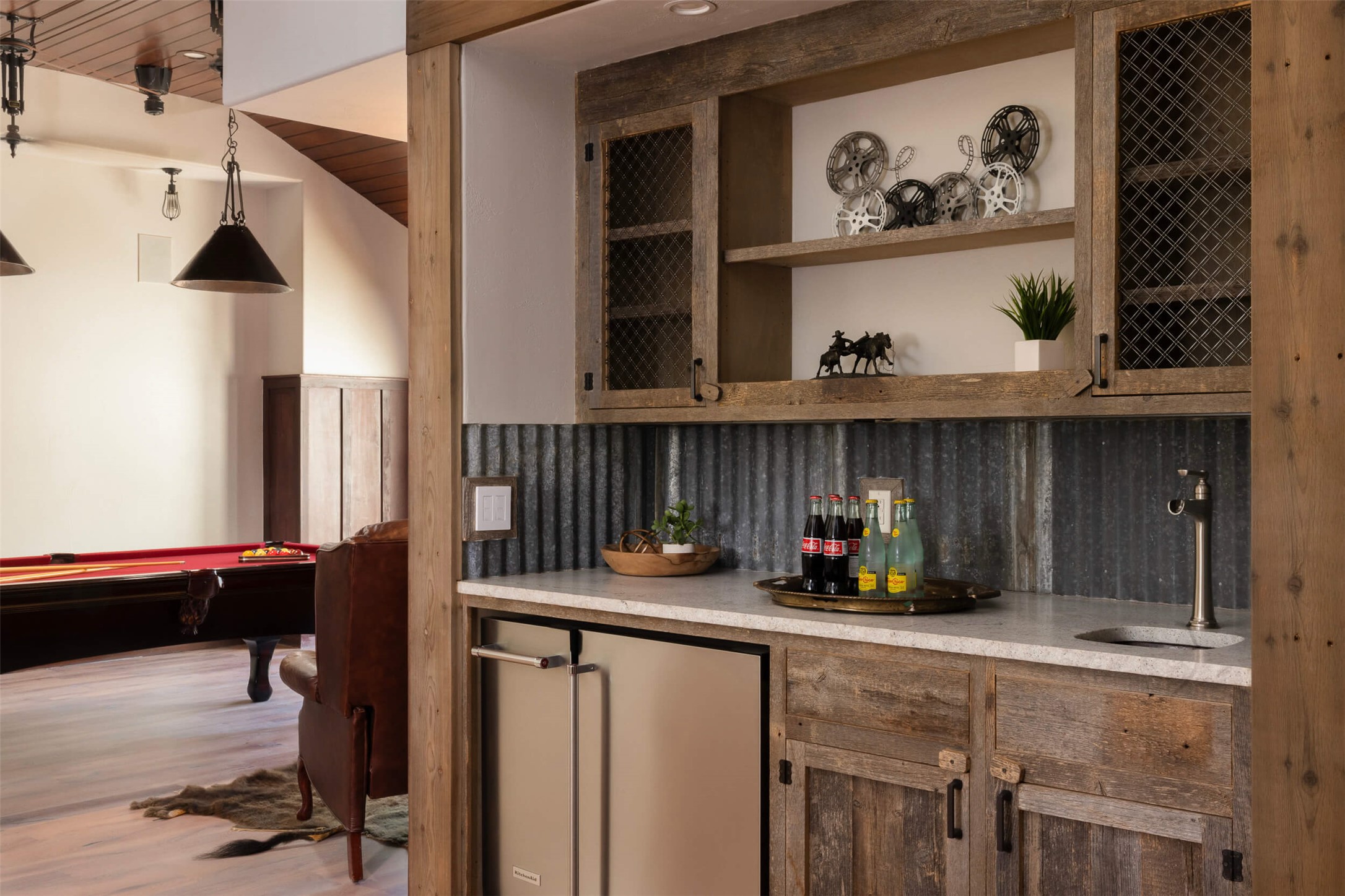 15016 Flat Top Ranch Road Austin, TX 78732 - Photo 35 of 40 Indoor wet bar featuring light countertops, open shelves, stainless steel refrigerator, hanging light fixtures, and billiards