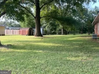 a big yard with lots of green space and trees