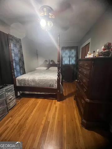 a bedroom with a bed and wooden floor