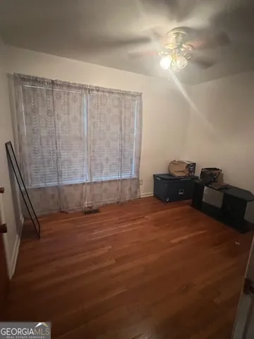 a view of a livingroom with furniture and staircase