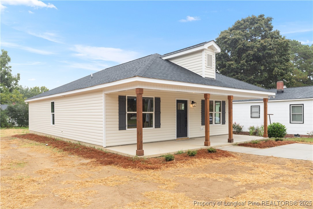 229 East Washington Street Coats, NC 27521 - Photo 2 of 24 a front view of a house with a yard and garage