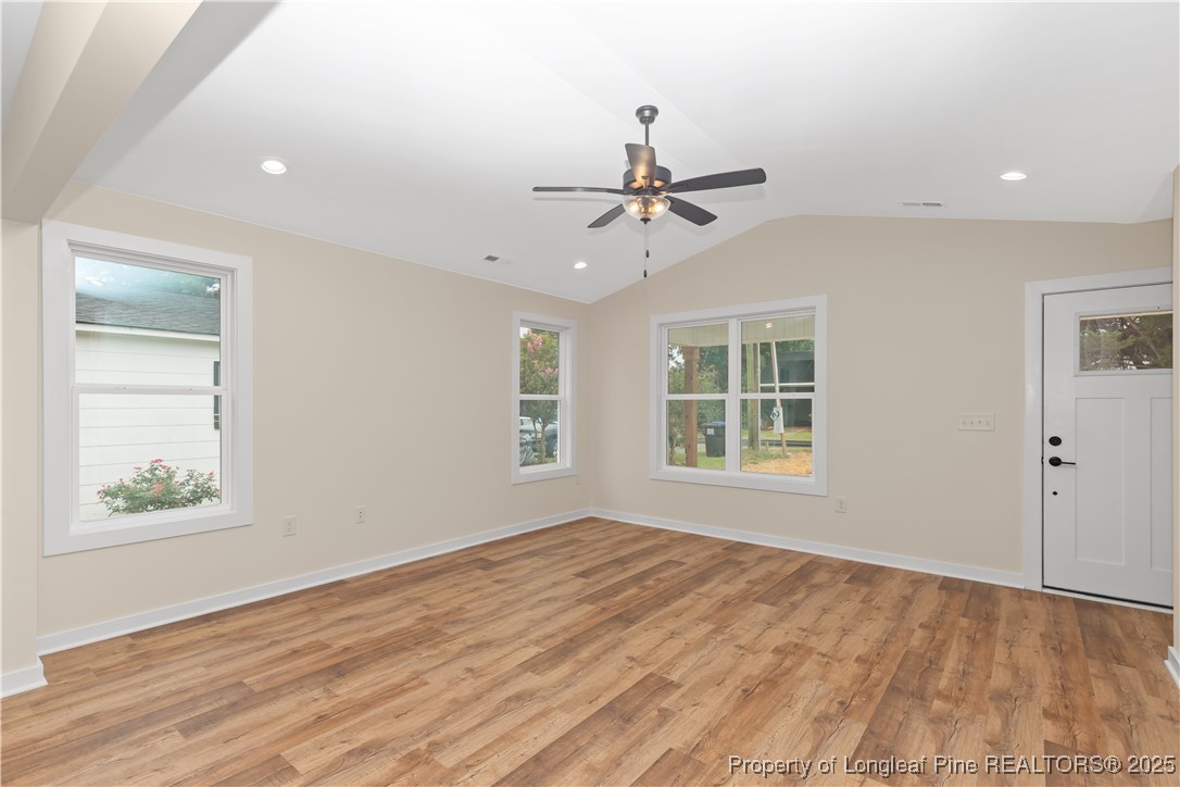 229 East Washington Street Coats, NC 27521 - Photo 8 of 24 a view of an empty room with a window and wooden floor
