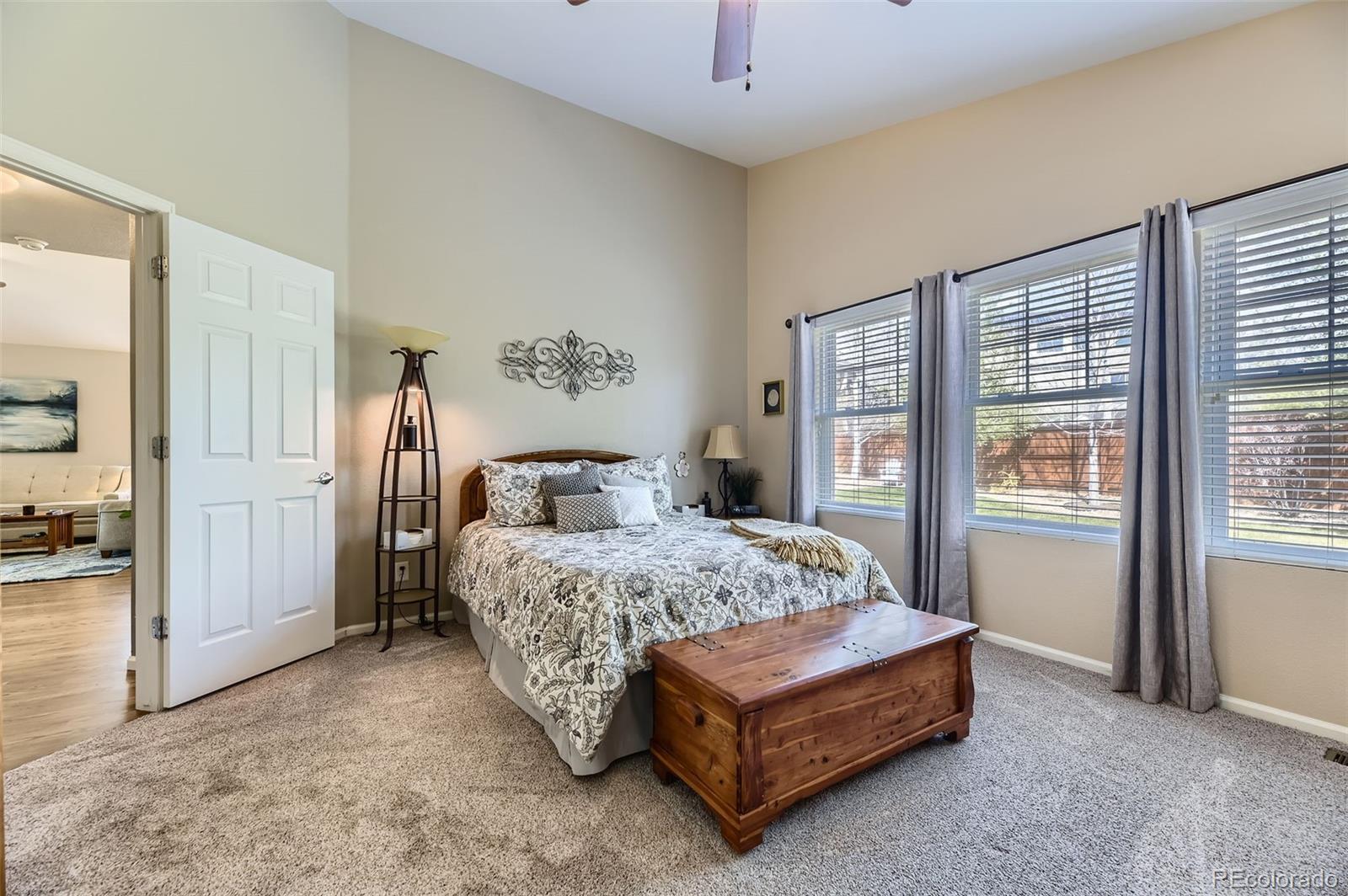 20040 East Doane Drive Aurora, CO 80013 - Photo 13 of 28 a bedroom with a bed a table and closet