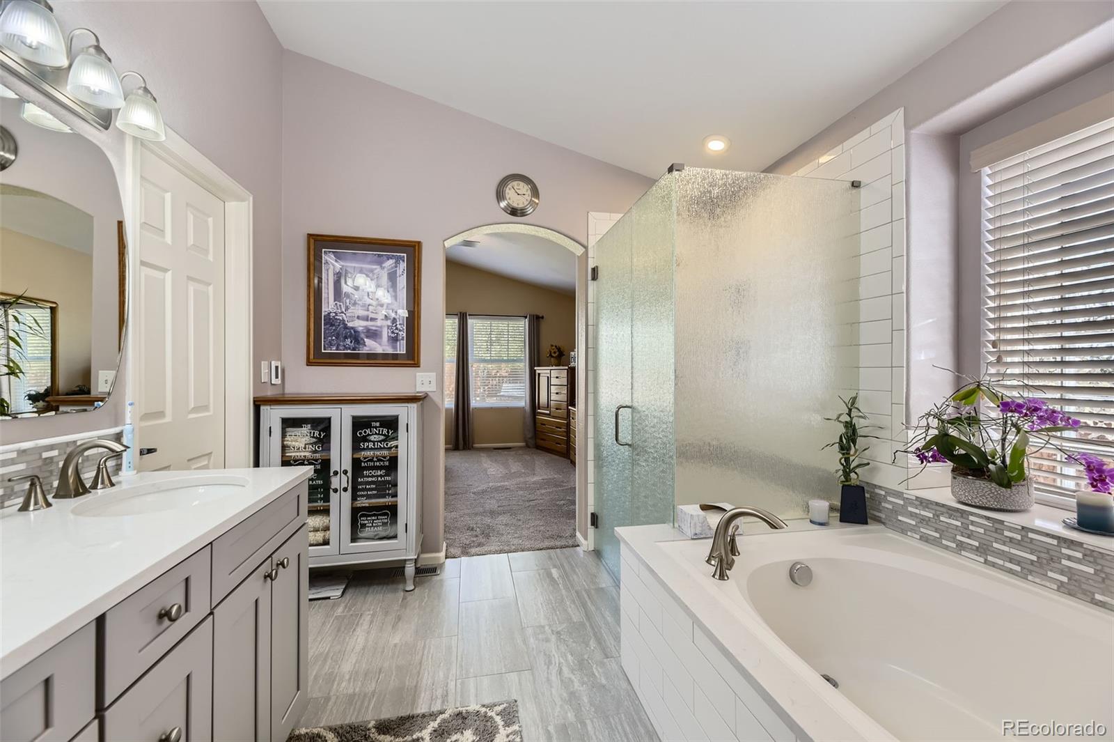 20040 East Doane Drive Aurora, CO 80013 - Photo 17 of 28 a spacious bathroom with a tub sink shower and mirror