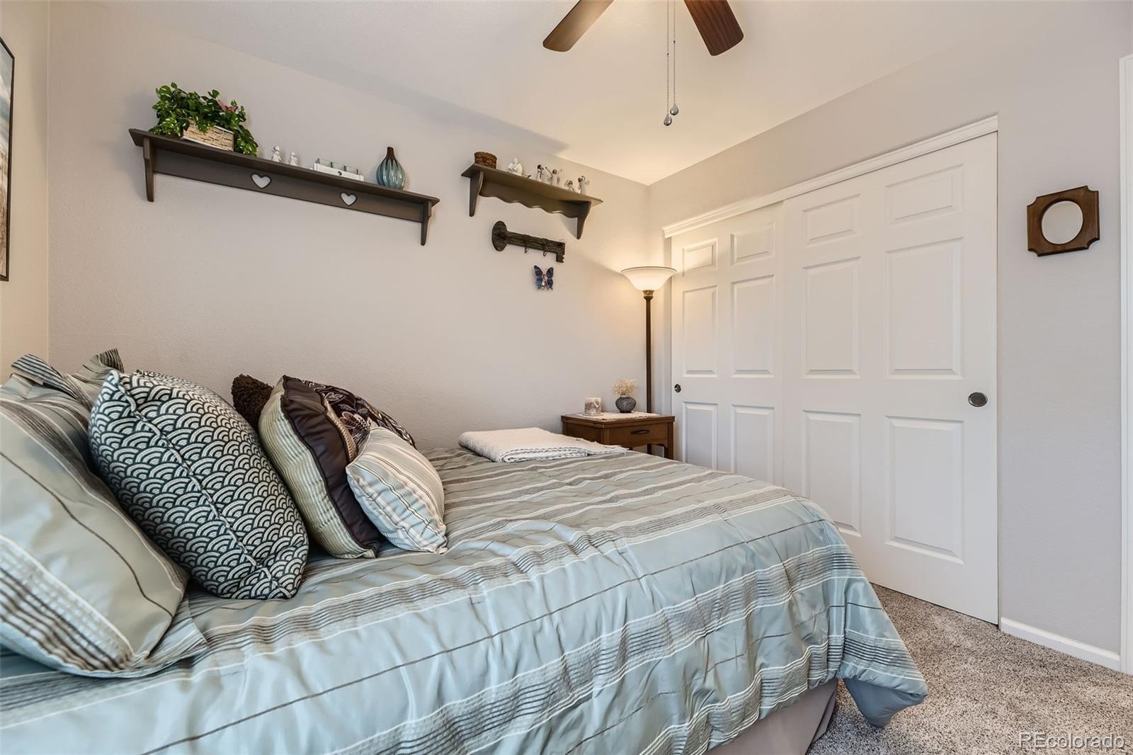 20040 East Doane Drive Aurora, CO 80013 - Photo 19 of 28 a bedroom with a bed and a ceiling fan