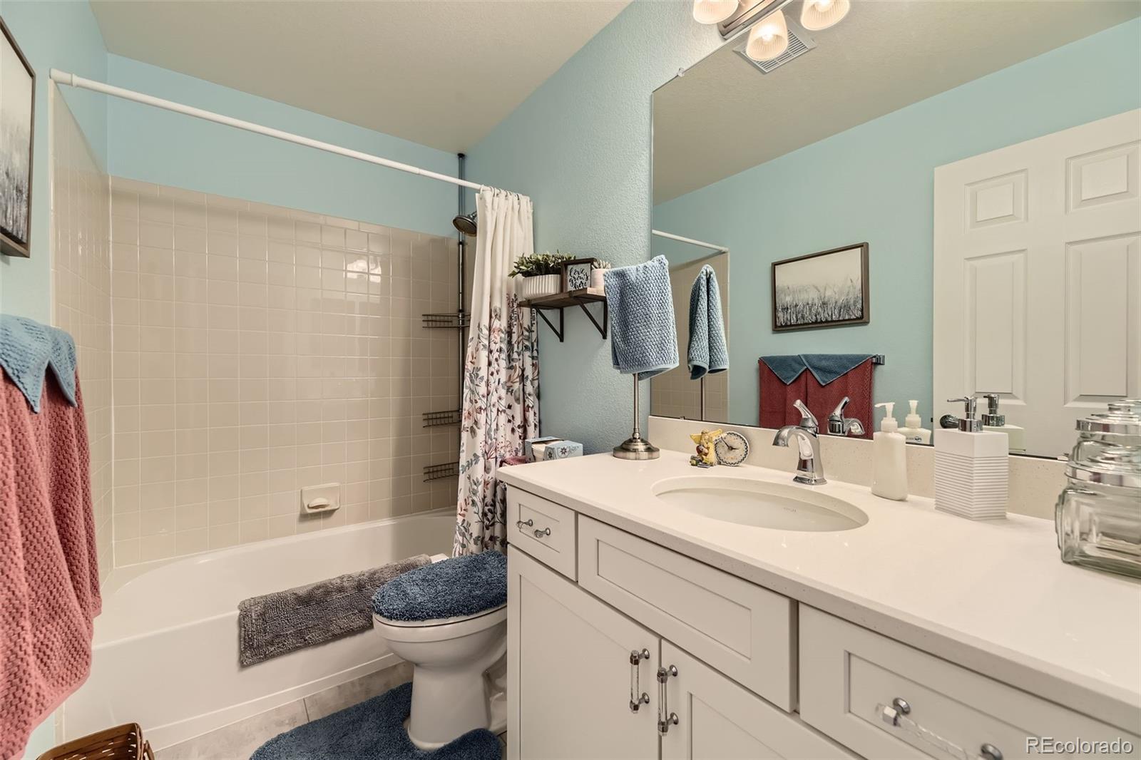 20040 East Doane Drive Aurora, CO 80013 - Photo 20 of 28 a bathroom with a sink a toilet and shower