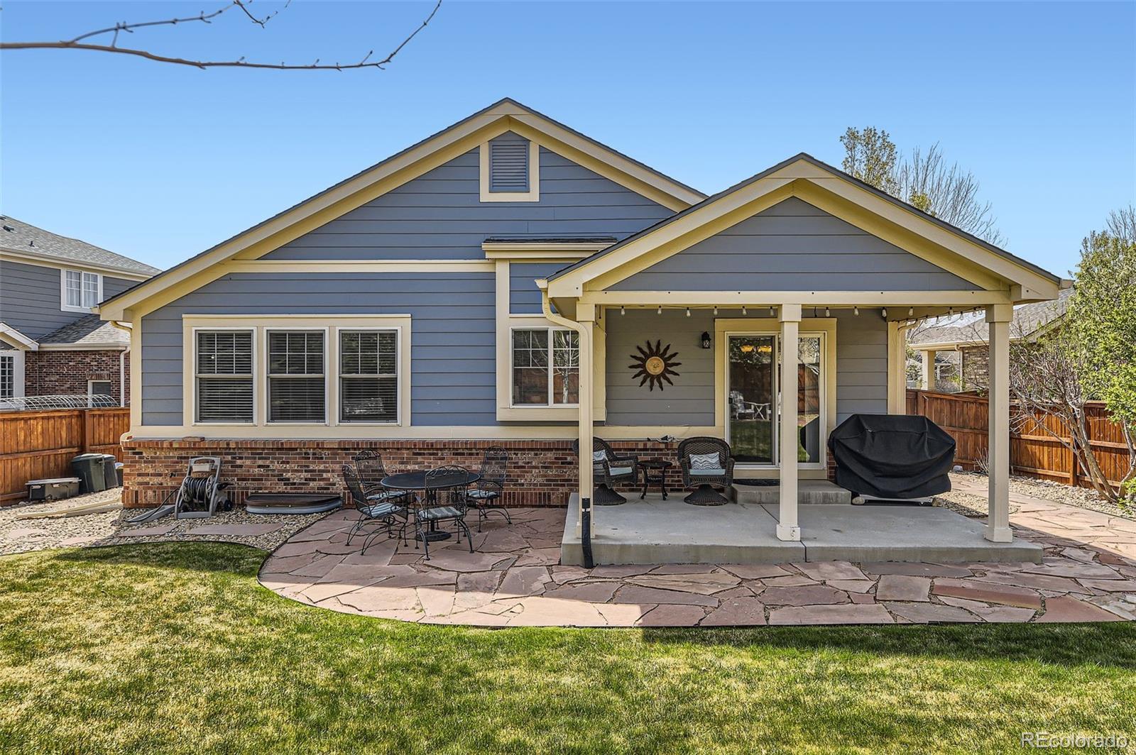20040 East Doane Drive Aurora, CO 80013 - Photo 27 of 28 a front view of a house with a yard outdoor seating and barbeque oven