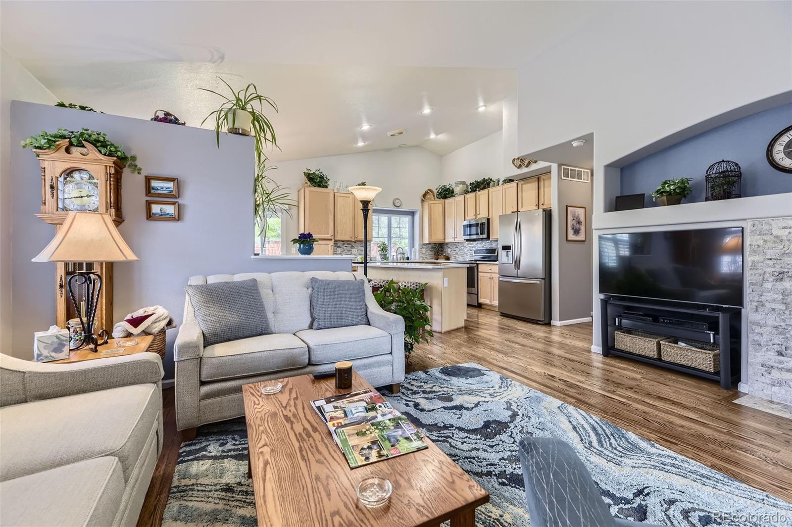 20040 East Doane Drive Aurora, CO 80013 - Photo 4 of 28 a living room with furniture and a flat screen tv
