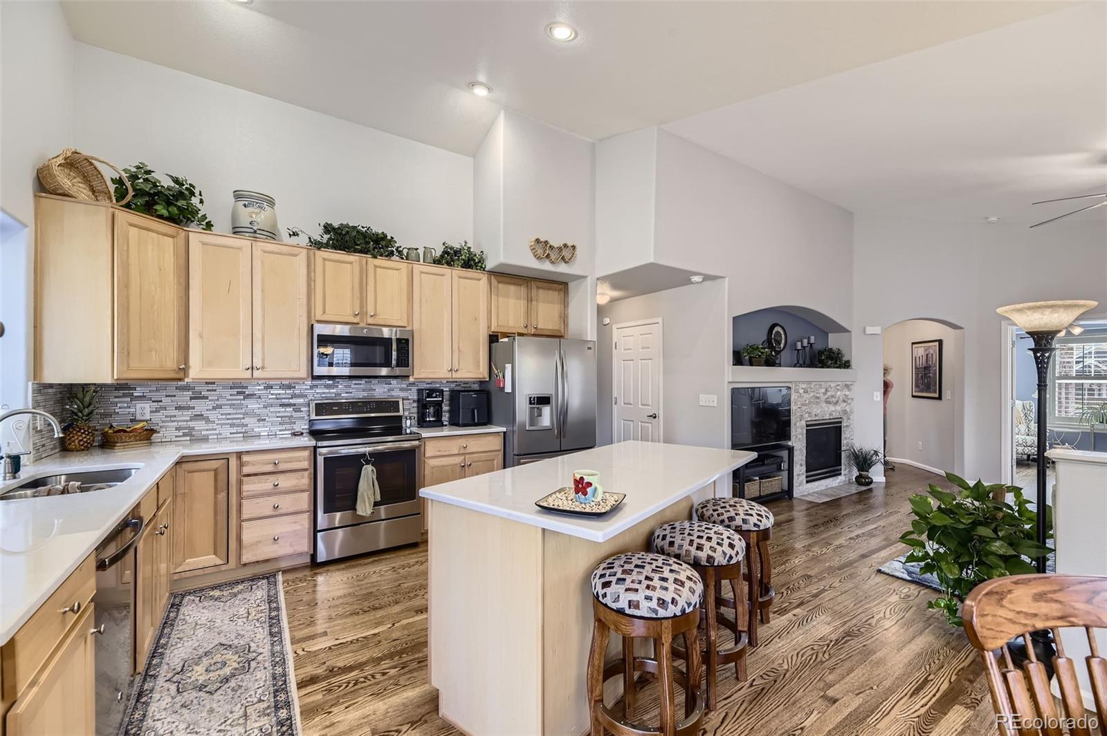 20040 East Doane Drive Aurora, CO 80013 - Photo 6 of 28 a kitchen with a sink stove and refrigerator