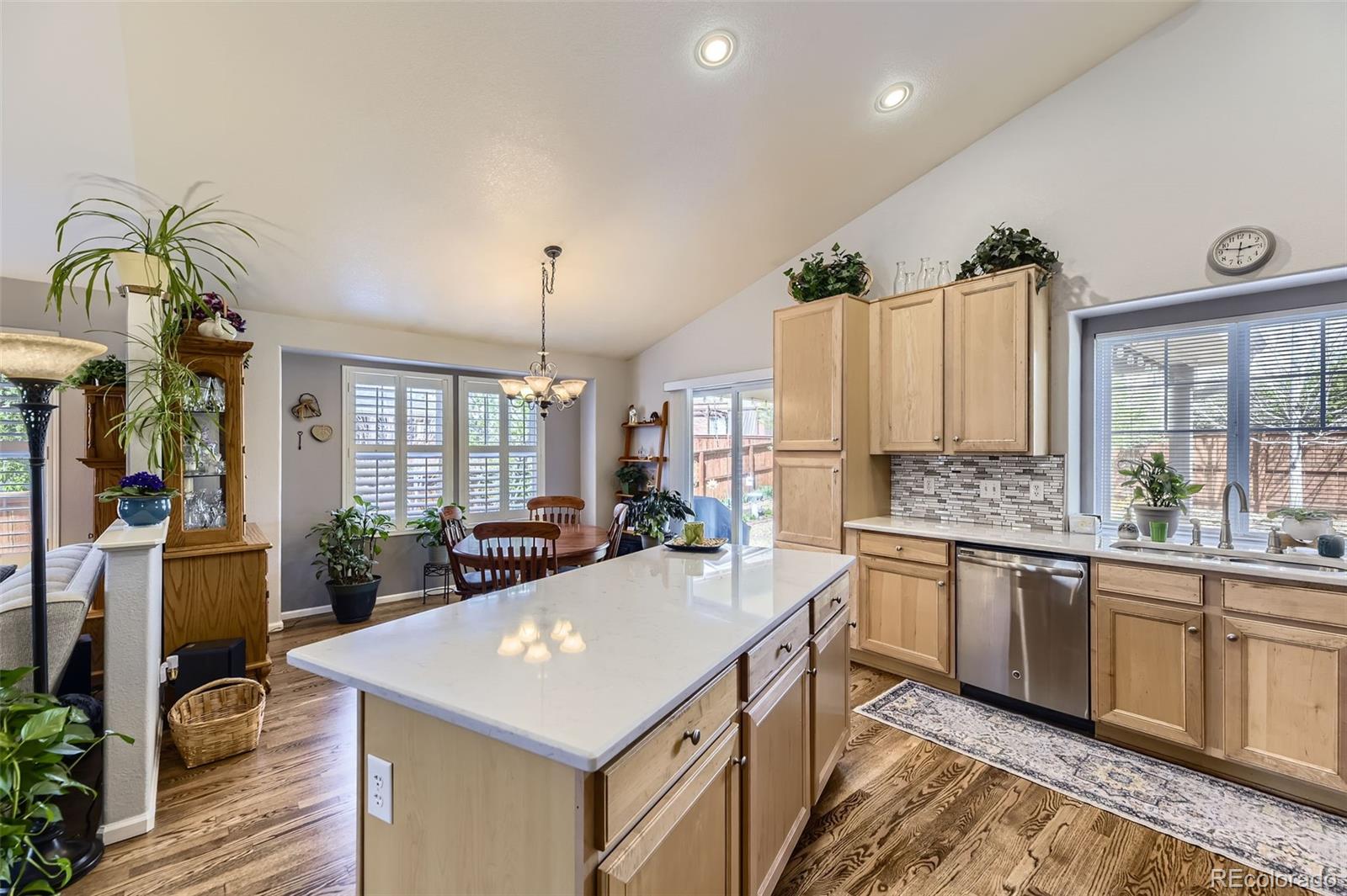 20040 East Doane Drive Aurora, CO 80013 - Photo 7 of 28 a kitchen with stainless steel appliances granite countertop a sink a stove and a refrigerator