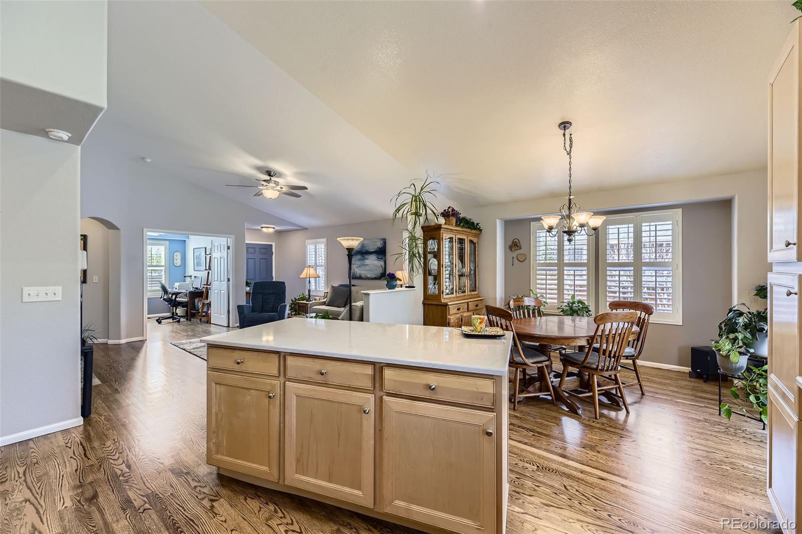 20040 East Doane Drive Aurora, CO 80013 - Photo 8 of 28 a room with stainless steel appliances kitchen island granite countertop a table chairs and a view of living room