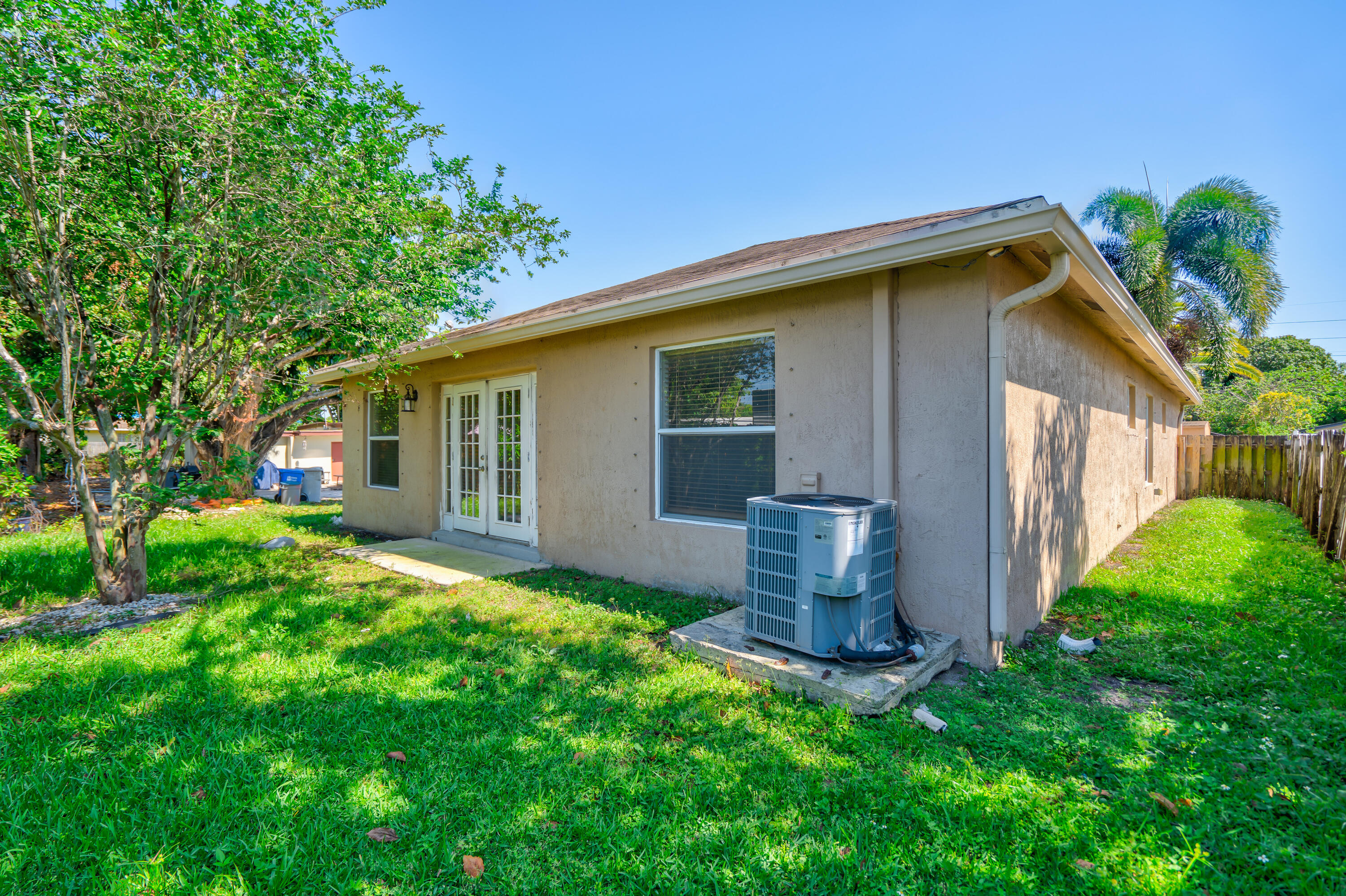 2241 Northwest 3rd Street Pompano Beach, FL 33069 - Photo 13 of 27 a backyard of a house with plants and barbeque oven