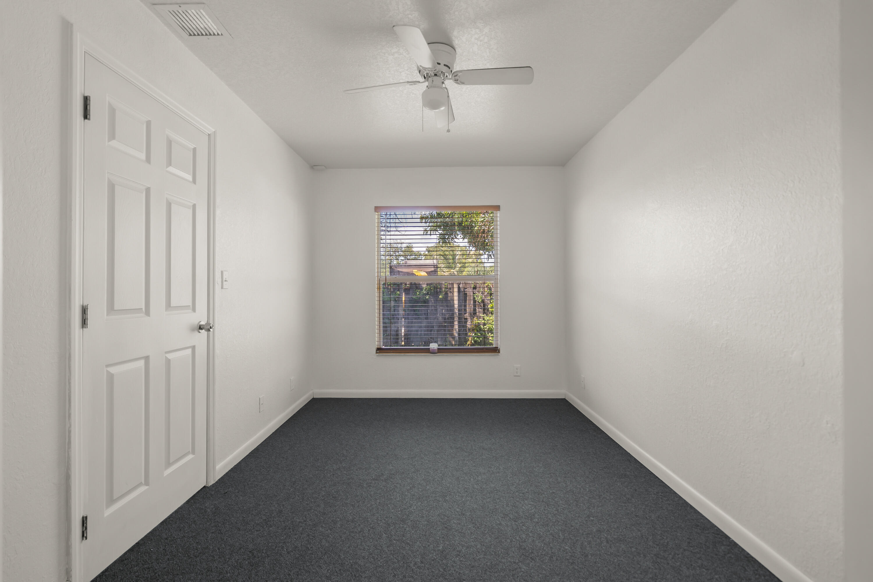 2241 Northwest 3rd Street Pompano Beach, FL 33069 - Photo 20 of 27 an empty room with windows and fan
