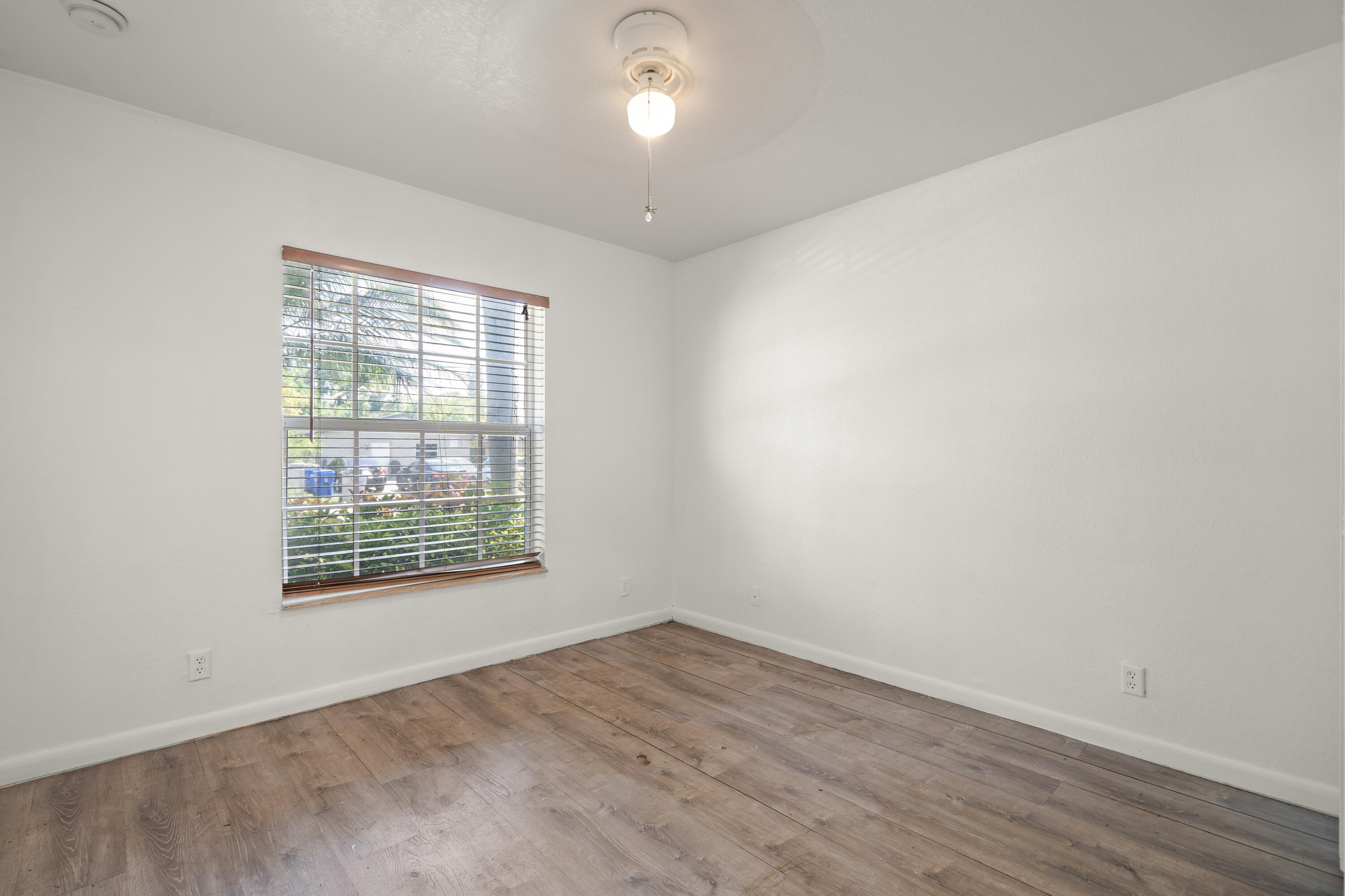 2241 Northwest 3rd Street Pompano Beach, FL 33069 - Photo 22 of 27 an empty room with wooden floor and windows