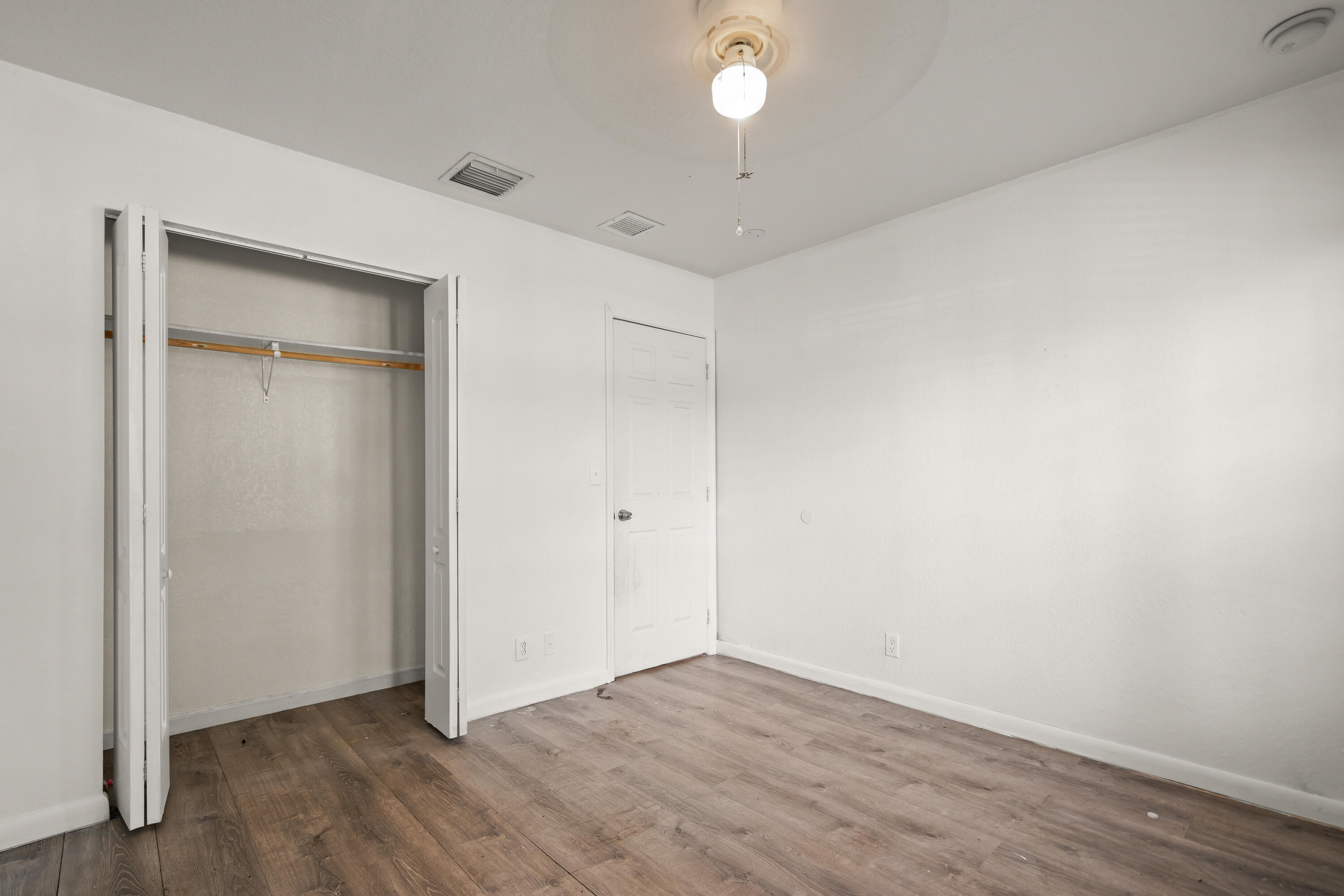 2241 Northwest 3rd Street Pompano Beach, FL 33069 - Photo 23 of 27 an empty room with wooden floor and a ceiling fan