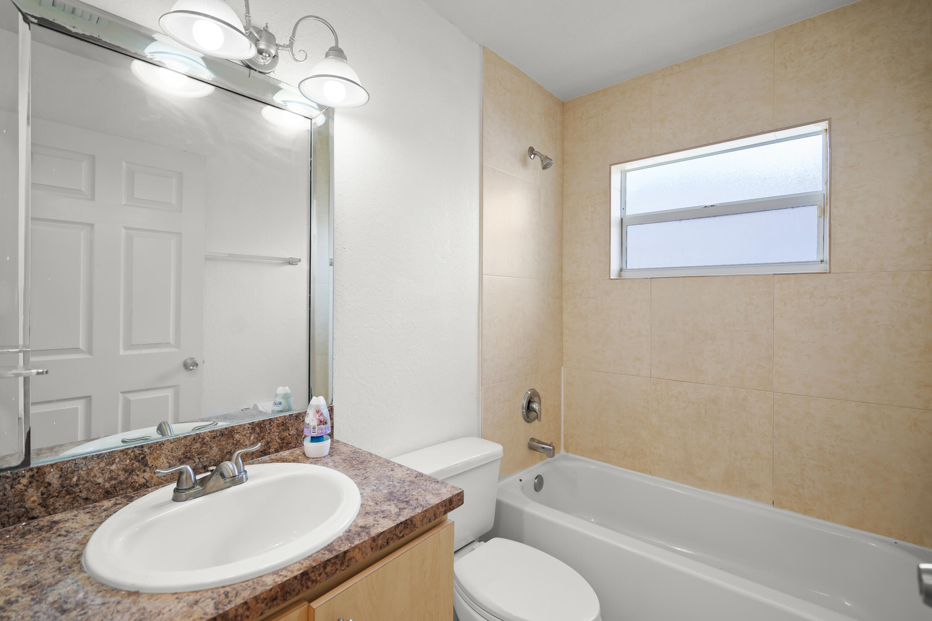 2241 Northwest 3rd Street Pompano Beach, FL 33069 - Photo 24 of 27 a bathroom with a granite countertop sink toilet a mirror and shower