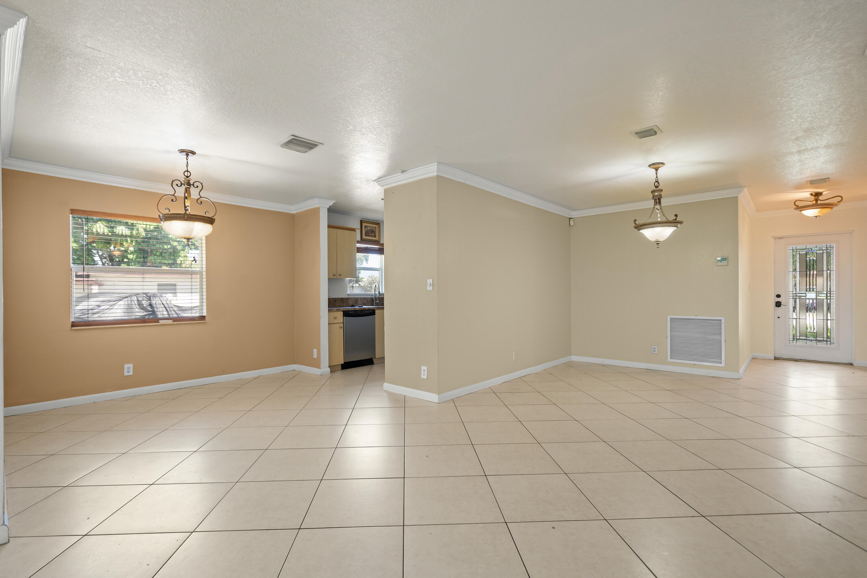 2241 Northwest 3rd Street Pompano Beach, FL 33069 - Photo 6 of 27 an empty room with kitchen and chandelier fan