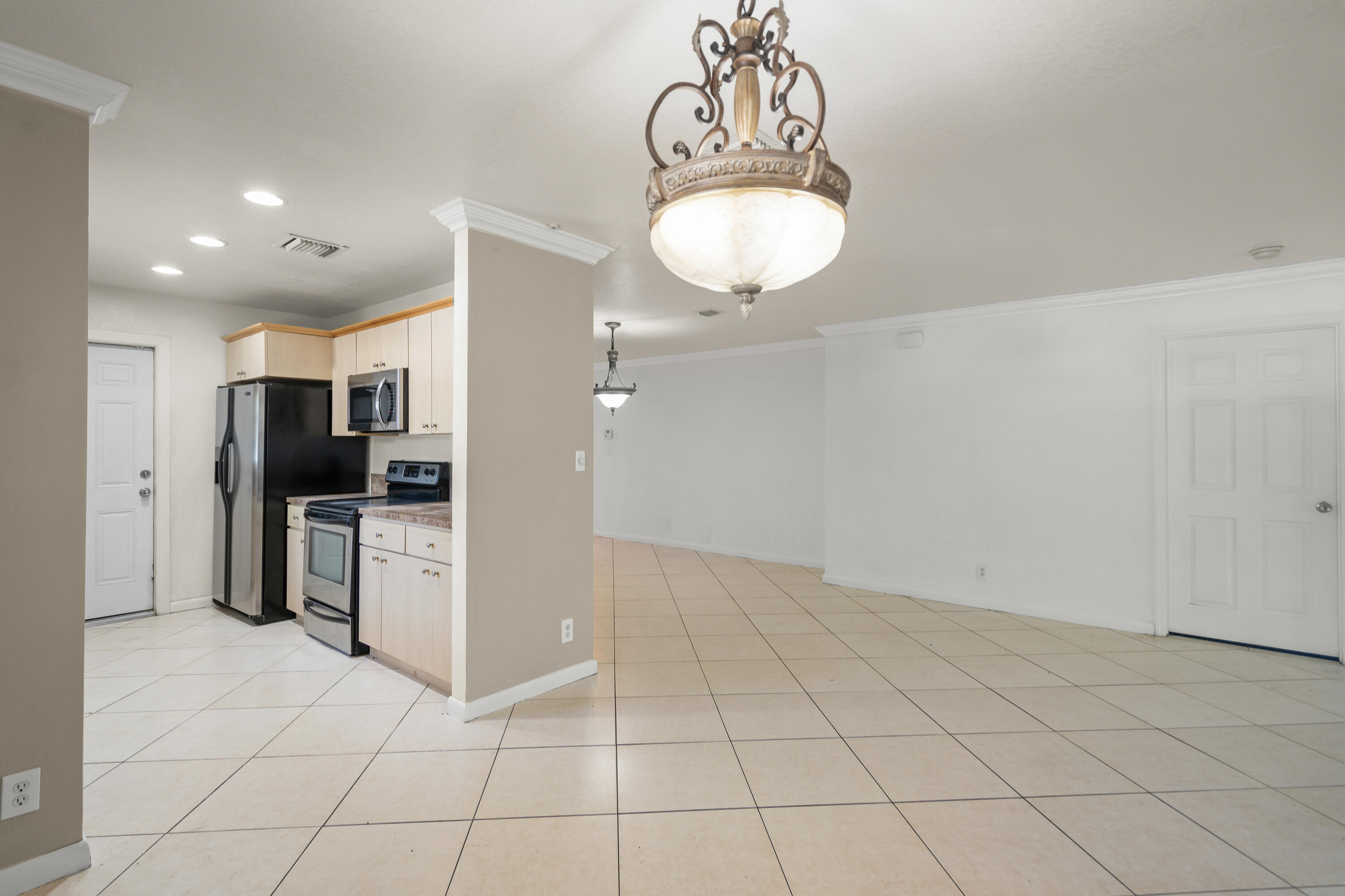 2241 Northwest 3rd Street Pompano Beach, FL 33069 - Photo 7 of 27 a kitchen with stainless steel appliances granite countertop a refrigerator and a sink