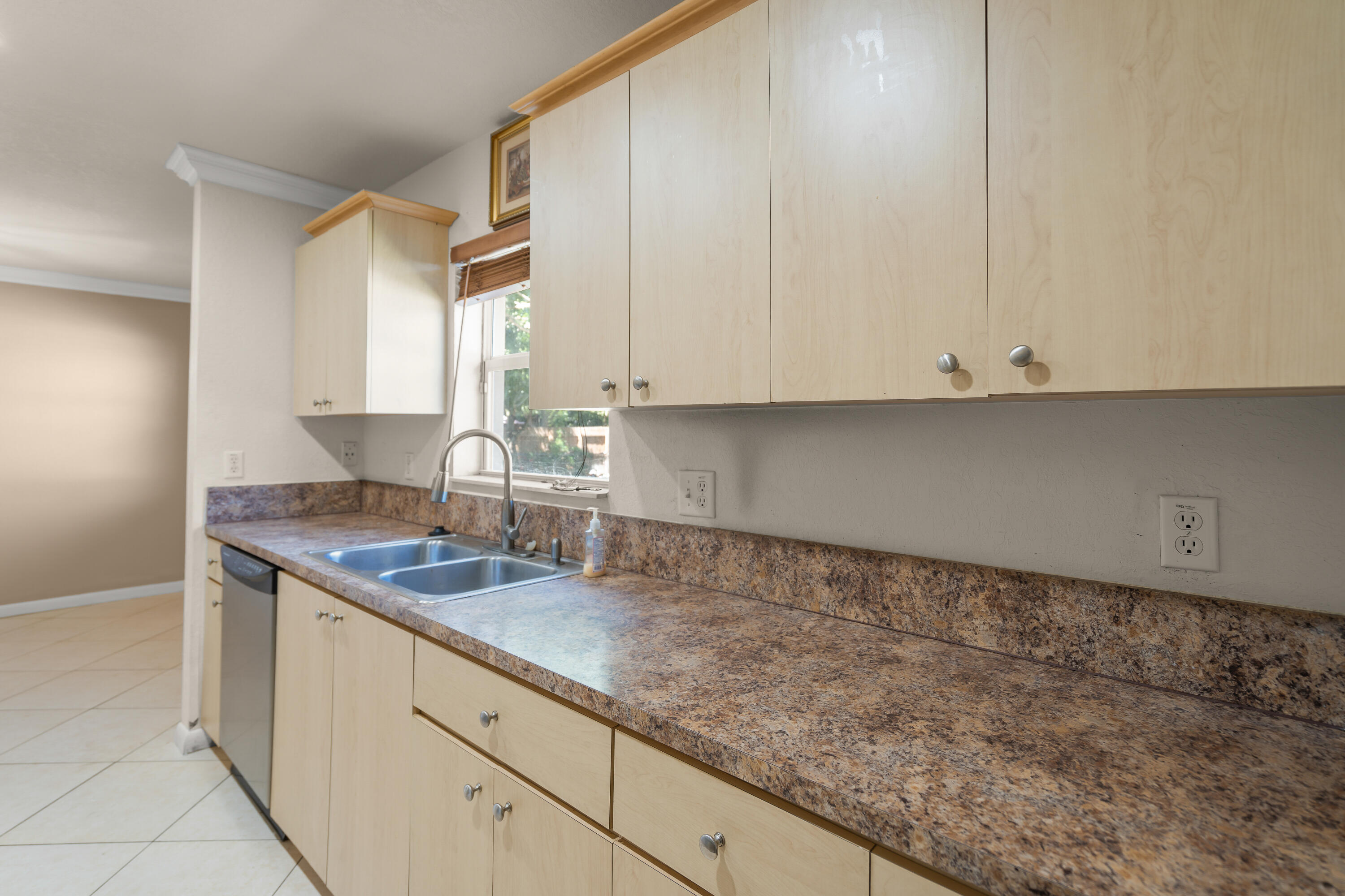 2241 Northwest 3rd Street Pompano Beach, FL 33069 - Photo 10 of 27 a kitchen with granite countertop white cabinets and a stove