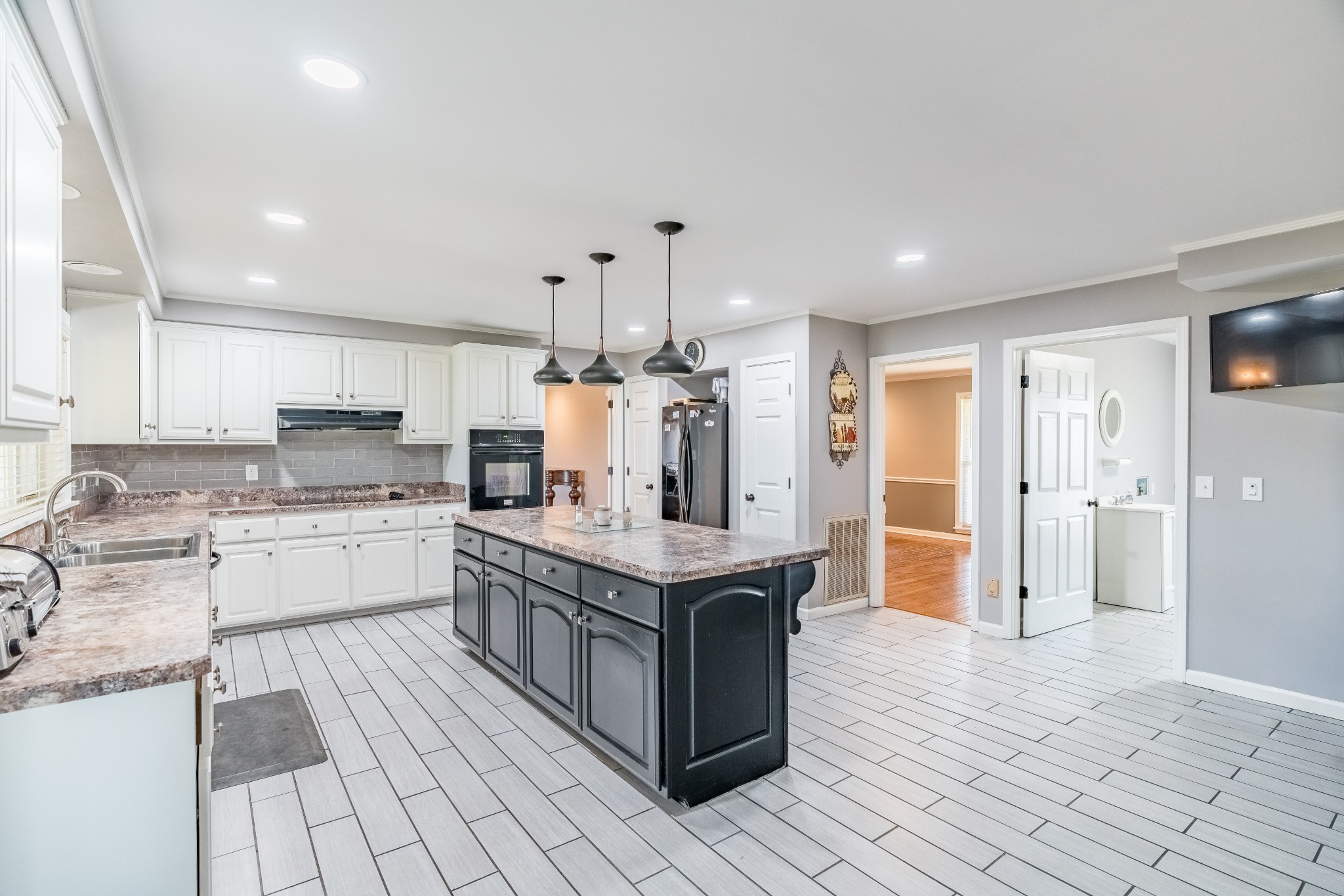 7135 Harmony Grove Road Crofton, KY 42217 - Photo 22 of 37 a large kitchen with stainless steel appliances granite countertop a large counter top and a stove