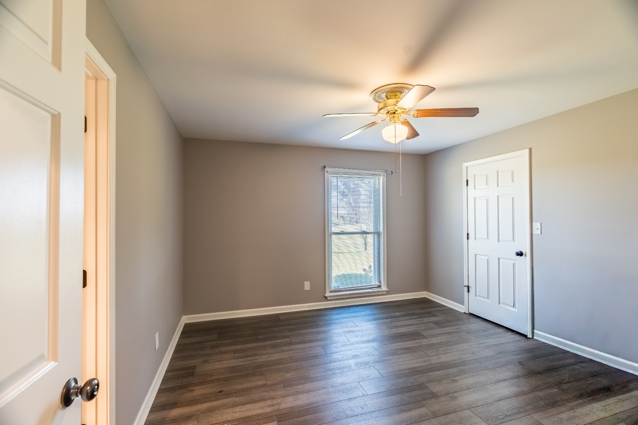 7135 Harmony Grove Road Crofton, KY 42217 - Photo 5 of 37 a view of empty room with wooden floor and fan