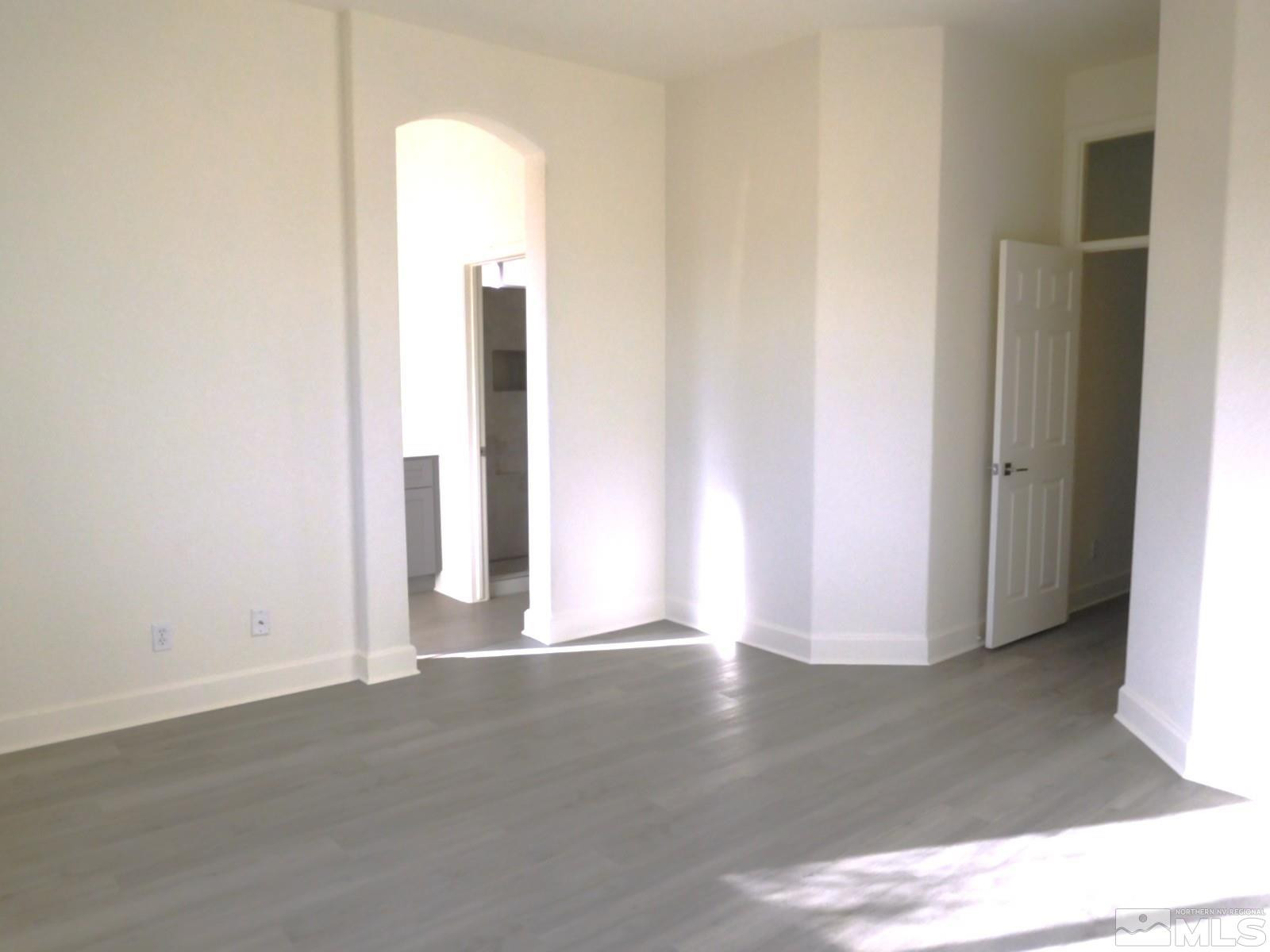 3463 Long Drive Minden, NV 89423 - Photo 13 of 36 an empty room with wooden floor and windows