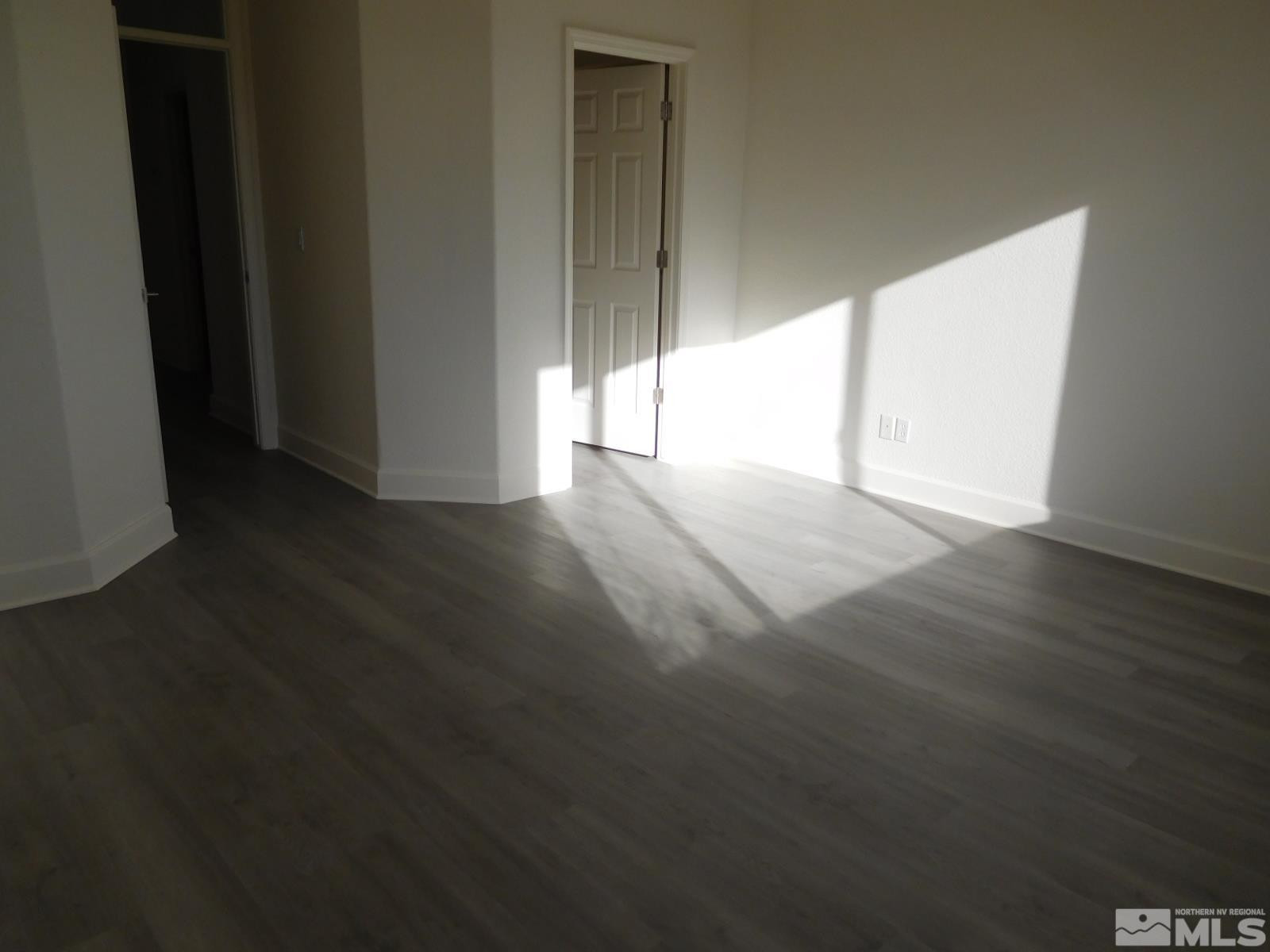 3463 Long Drive Minden, NV 89423 - Photo 14 of 36 an empty room with wooden floor and windows