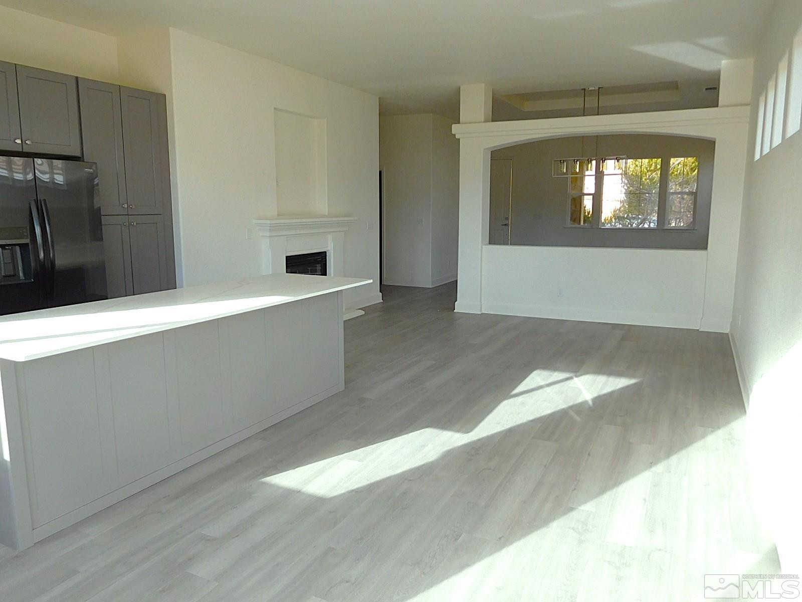 3463 Long Drive Minden, NV 89423 - Photo 6 of 36 a view of a hallway with wooden floor and a living room