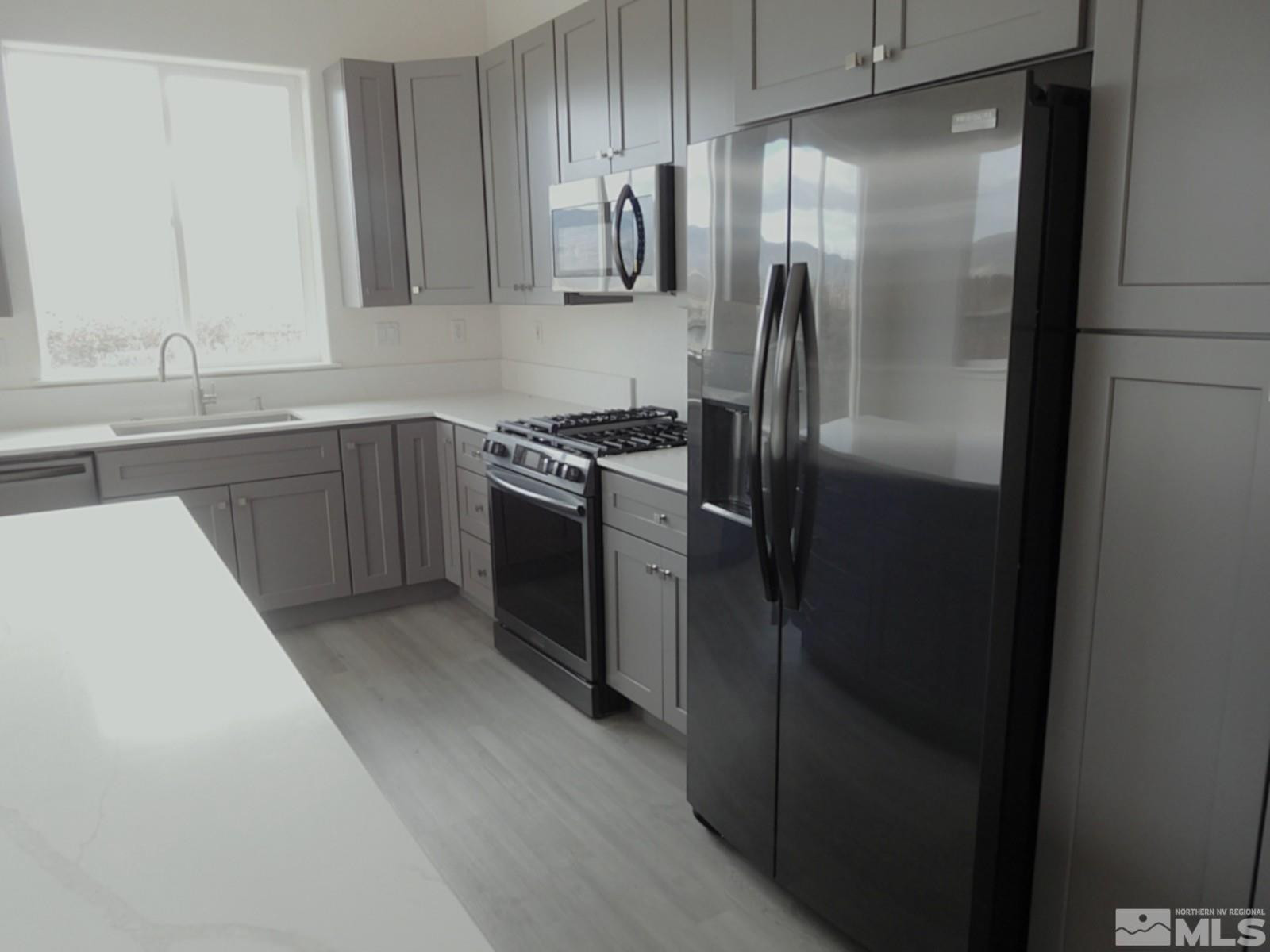 3463 Long Drive Minden, NV 89423 - Photo 7 of 36 a kitchen with stainless steel appliances granite countertop a refrigerator and a sink