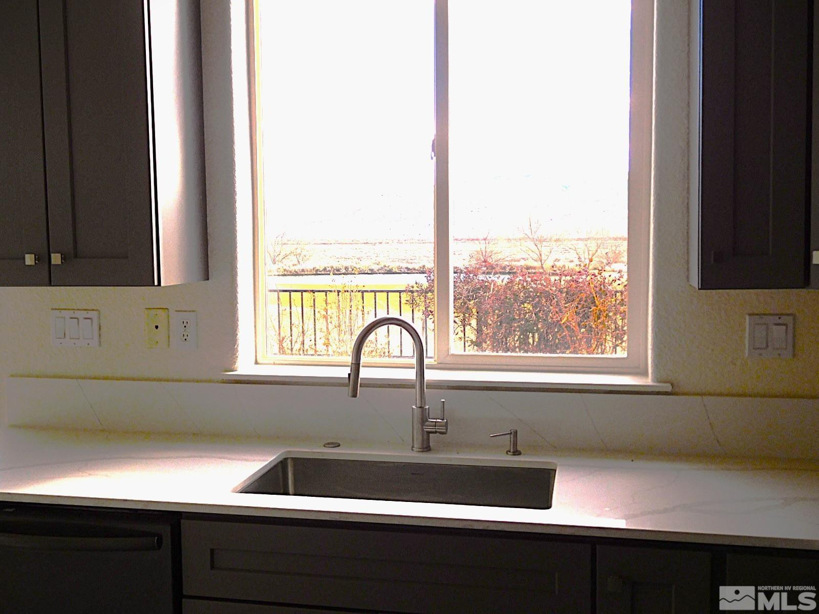 3463 Long Drive Minden, NV 89423 - Photo 9 of 36 a sink with a window and cabinets