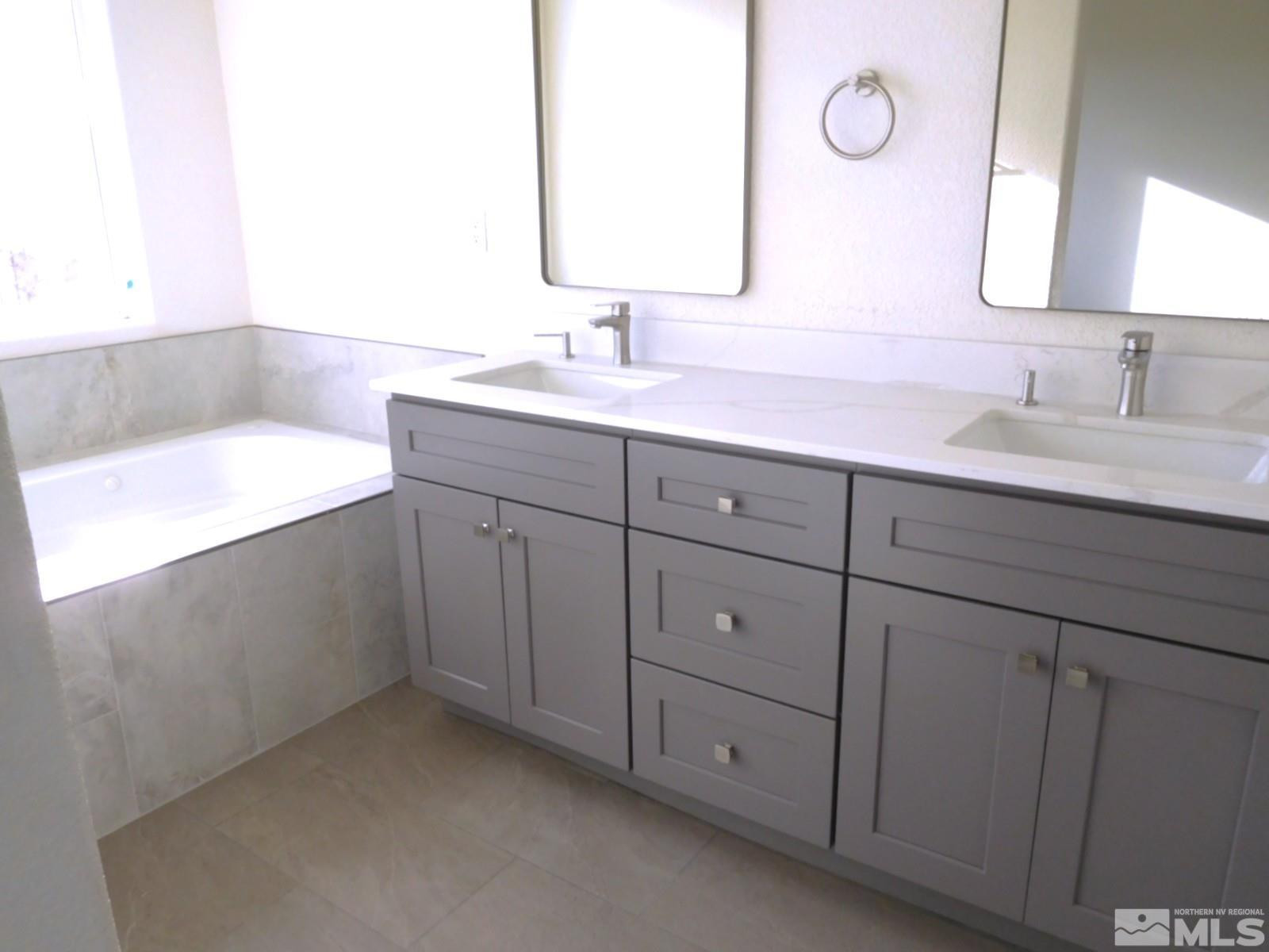 3463 Long Drive Minden, NV 89423 - Photo 10 of 36 a bathroom with a double vanity sink and mirror