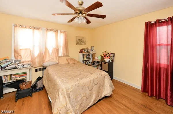 a bed sitting in a bedroom next to a window