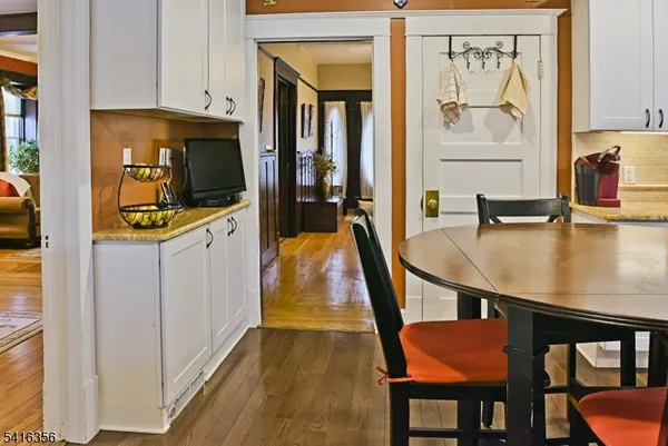 a vase of flowers sitting on a table with window