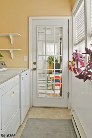 an aerial view of residential houses with outdoor space and parking