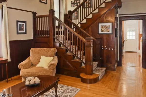 a living room with furniture a flat screen tv and floor to ceiling window
