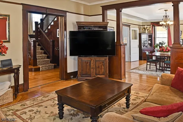 a kitchen with stainless steel appliances granite countertop a dining table chairs refrigerator and sink