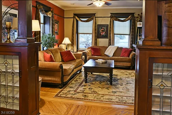 a kitchen with stainless steel appliances granite countertop a stove a refrigerator a dining table and chairs