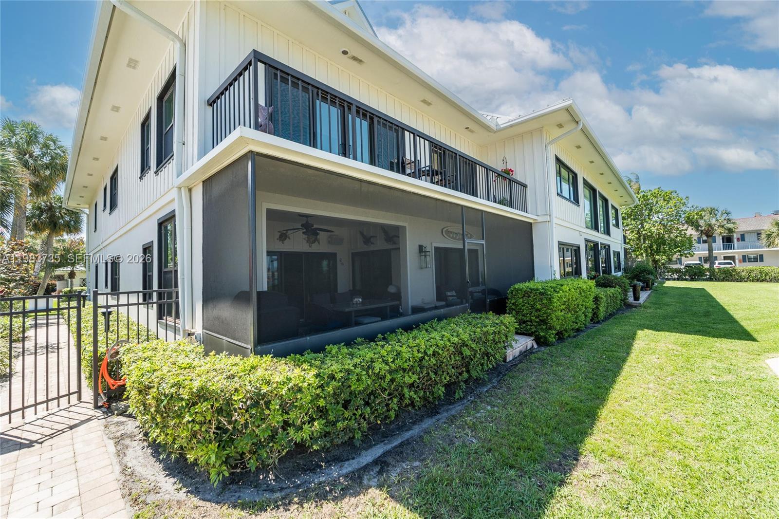 851 Saturn Street, Unit D Jupiter, FL 33477 - Photo 59 of 60 a view of a building with a yard