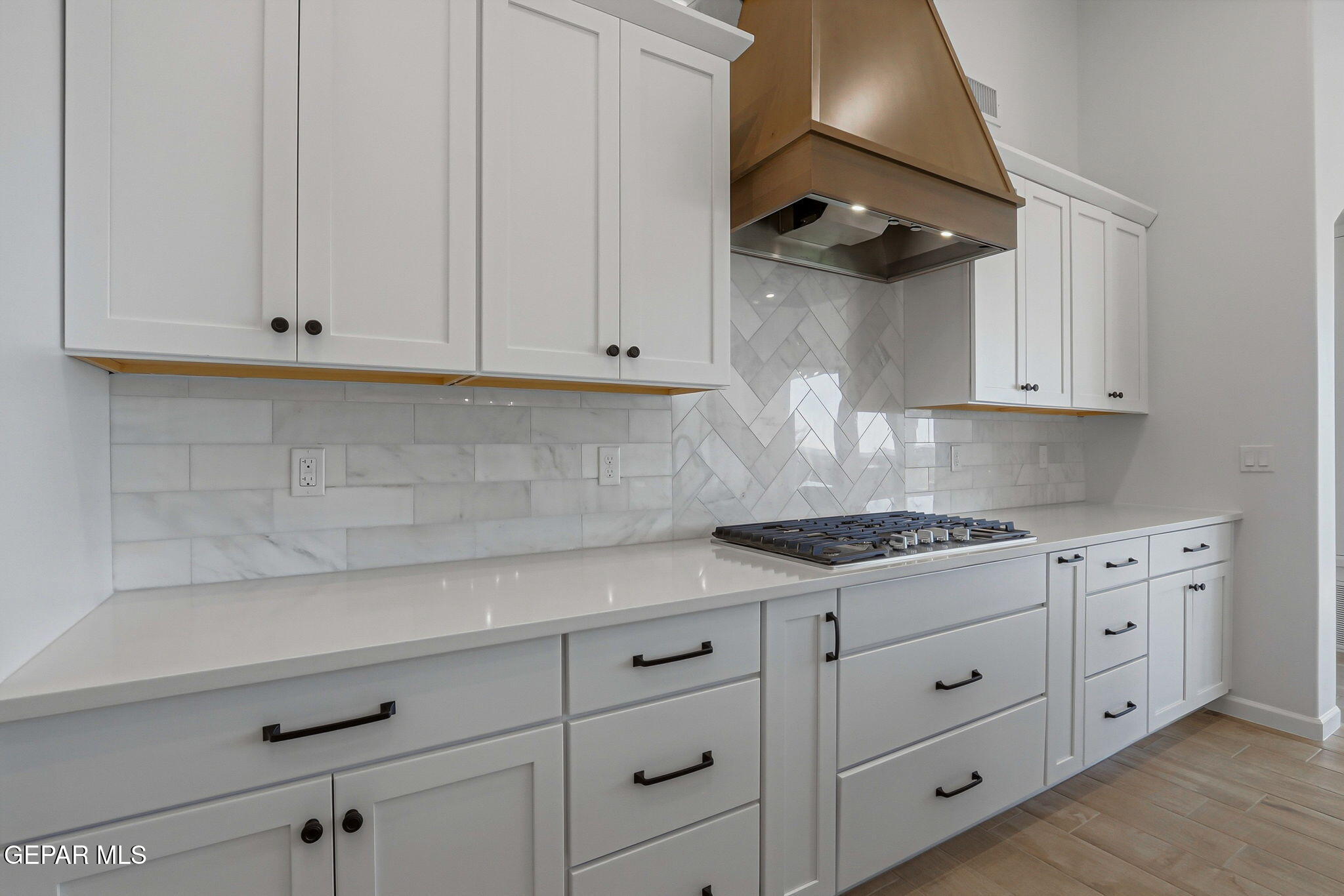 7416 Cimarron Rim Drive El Paso, TX 79911 - Photo 18 of 58 a kitchen with white cabinets and a stove with wooden cabinets