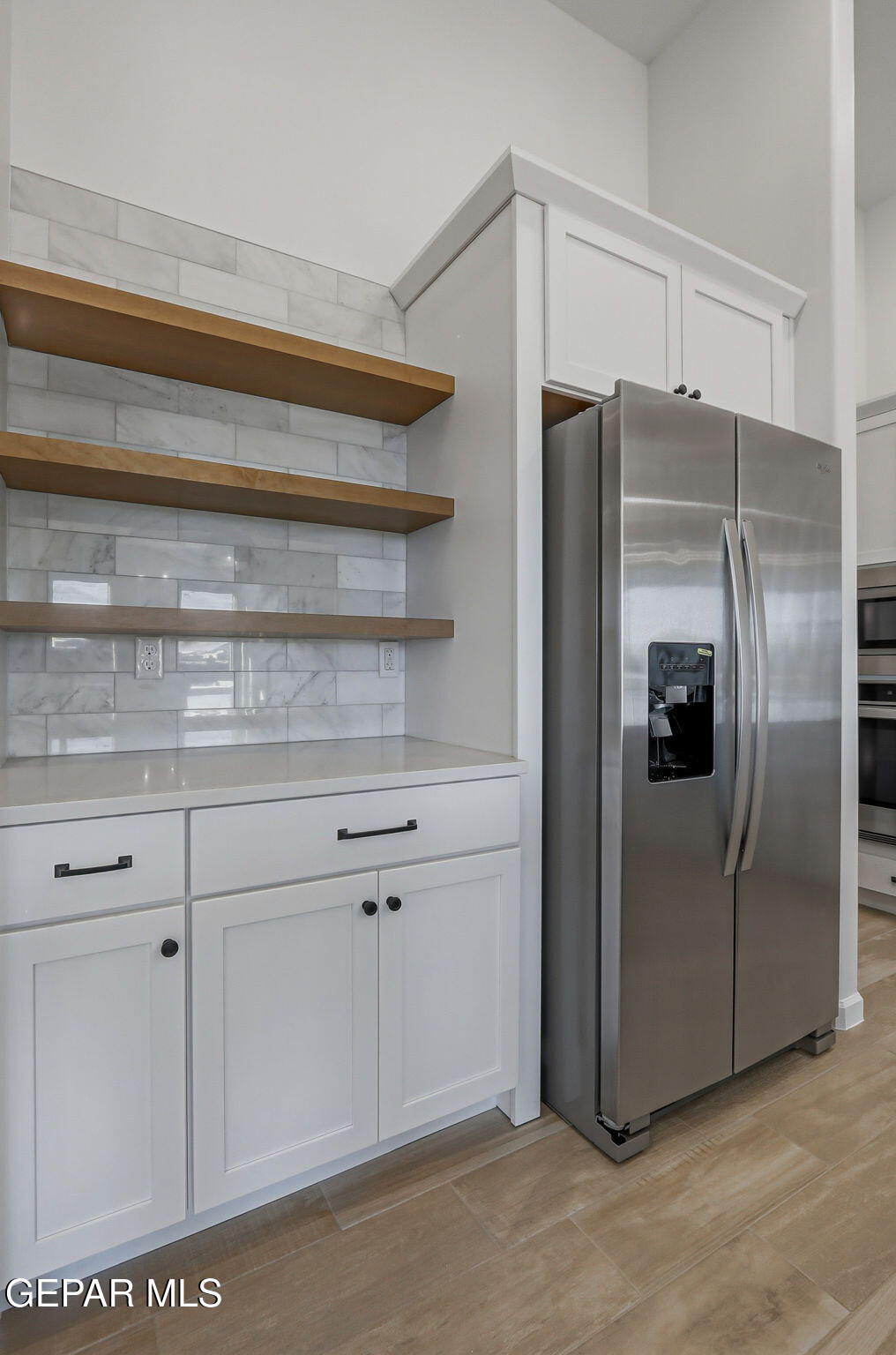 7416 Cimarron Rim Drive El Paso, TX 79911 - Photo 19 of 58 a kitchen with stainless steel appliances a refrigerator and cabinets